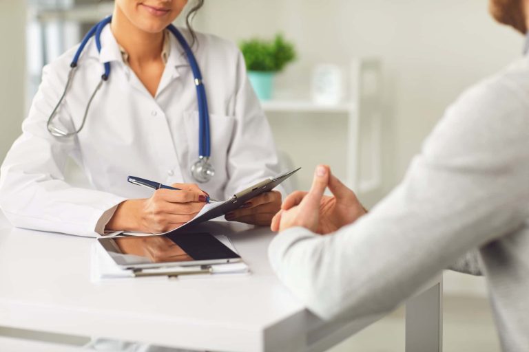 A meeting between a doctor and a patient in a clinical setting. 